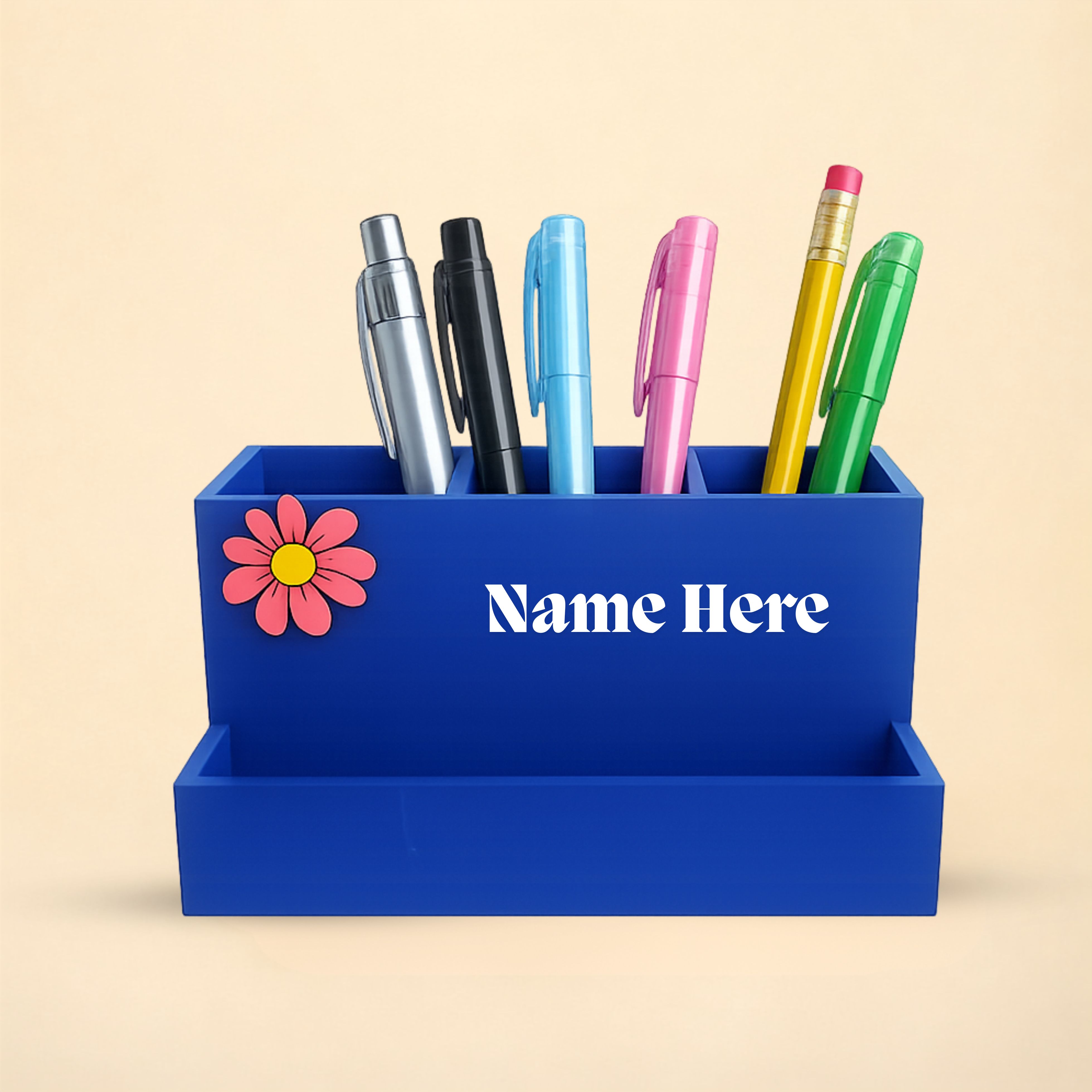 Personalized blue desk organizer with a floral accent and three compartments . 